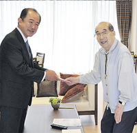 市長から敬老祝い金を受け取る 　市内最高齢の亀岡健次さんは、 　元気な笑顔で応じていた