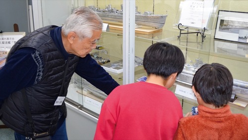 子どもたちに模型の解説をする野田さん（左）