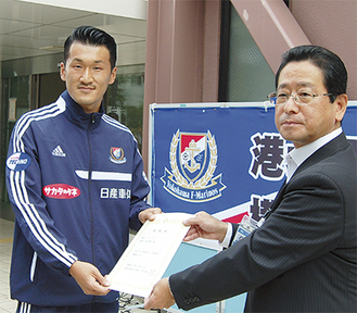 小川区長（右）から委嘱状を受け取る富澤選手