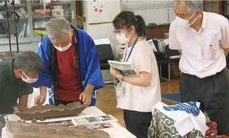 文化財調査で、神額の説明を行う村上さん(左から２人目)