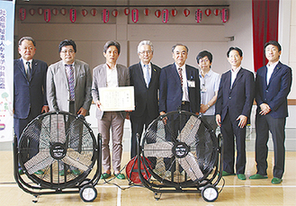 記念撮影を行う西田会長（左から３人目）ら関係者