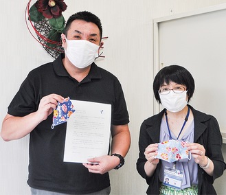 夏らしいデザインの手作りマスクを手にする佐藤所長（左）と林センター長