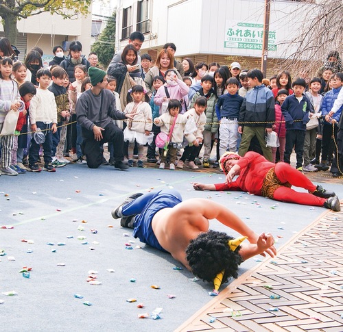 飴を投げられ、倒れる「鬼」たち