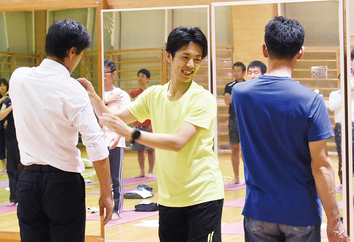 参加者に直接指導する萩原さん（中央）