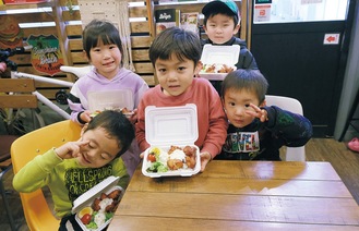 弁当を受け取り笑顔の子どもたち