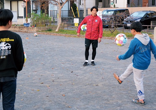 公園でボールを蹴る子どもたち