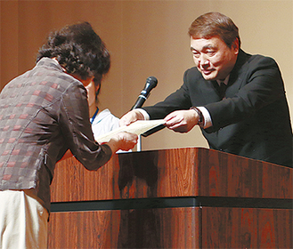 太田会長（右）から表彰状を受け取る飼い主