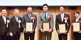 木田会長（左から２人目）と目録を持つ各区の区長ら