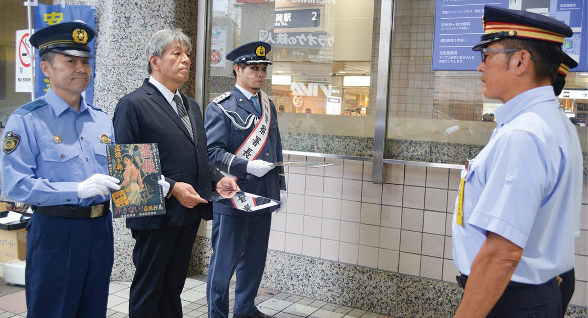 両駅長にポスターとミラーを手渡す森川署長ら
