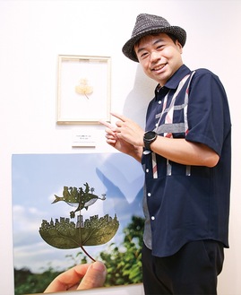みなとみらいを表現した作品を前に笑顔を見せるリトさん