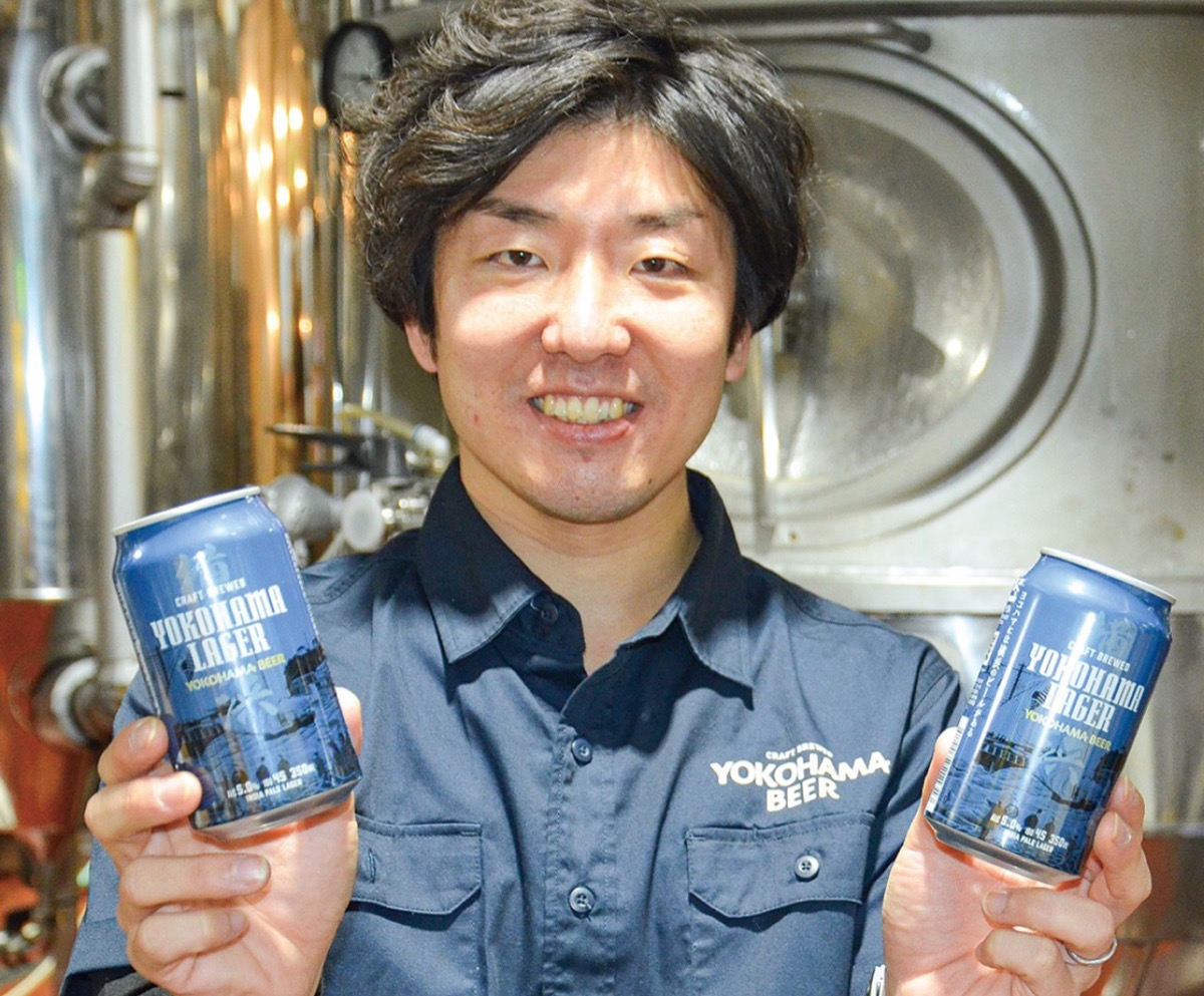 第1弾の缶ビールを手に横内さん