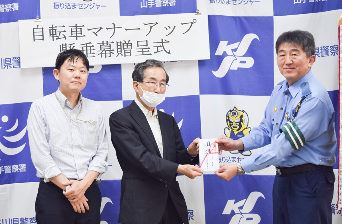 懸垂幕を寄贈した馬場会長(中央)と志波会長(左)