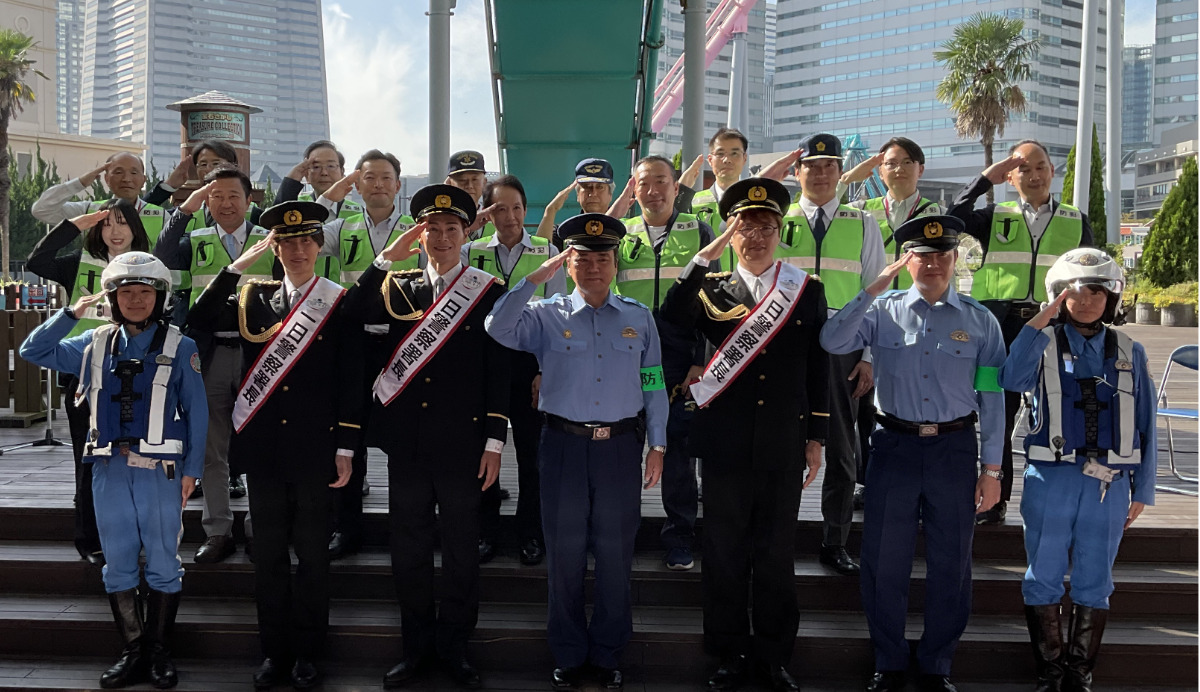 横浜港防犯協力会など関連団体や女性白バイ隊の「ホワイトエンジェルス」らと共に、敬礼ポーズで