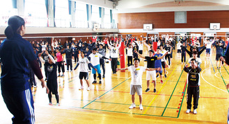 東海大体操部の学生に合わせて準備体操をする参加者