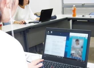 パソコン画面上で会話する女性（横浜市提供）