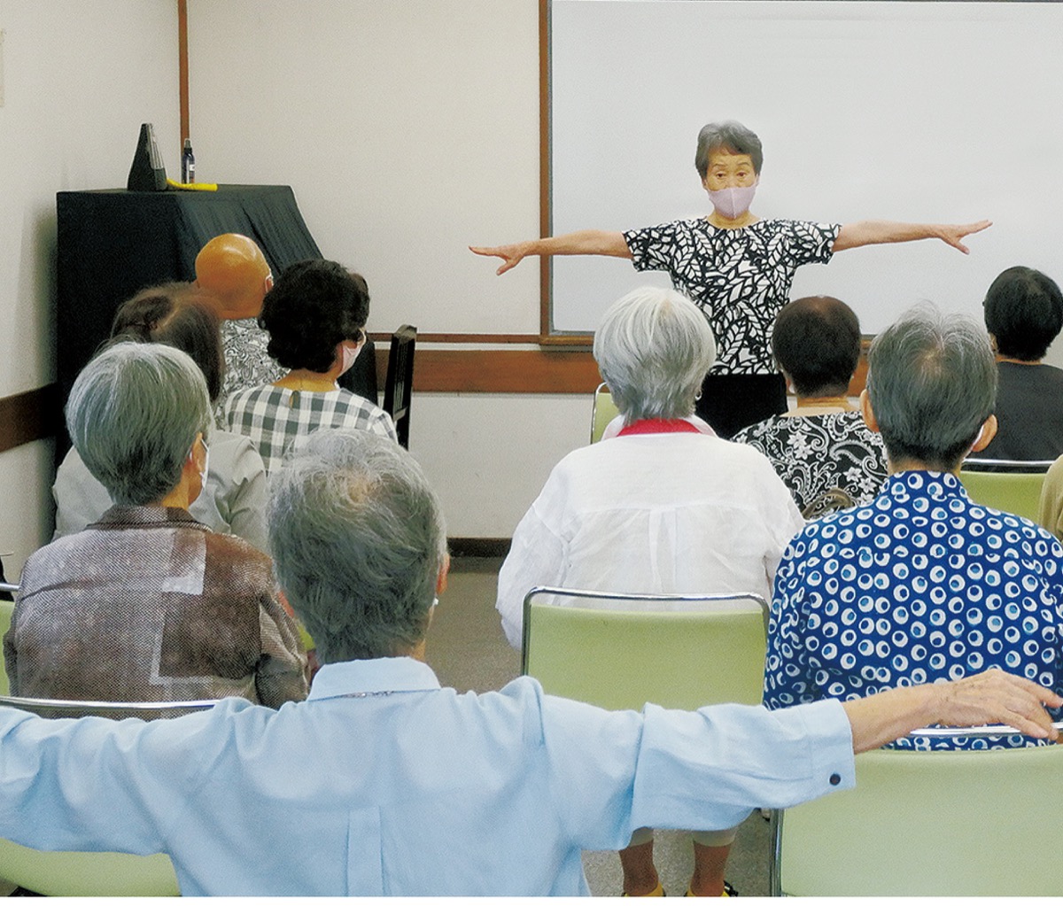 参加者と運動する加藤さん（後方）