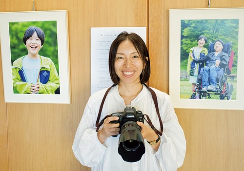 作品と一緒に笑顔を見せる中祖さん