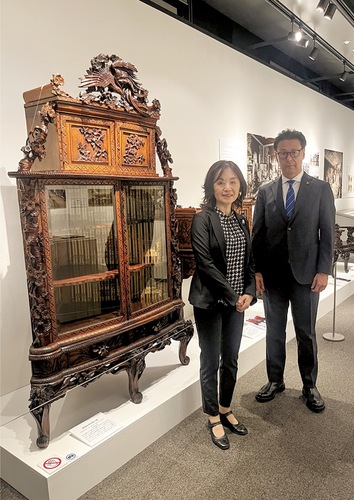 横浜彫刻家具を前に山本さん（右）