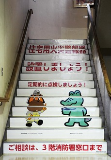 1階階段に登場した広報イラスト。横浜市消防のマスコット「ハマくん」と鶴見区の「ワッくん」が呼びかける