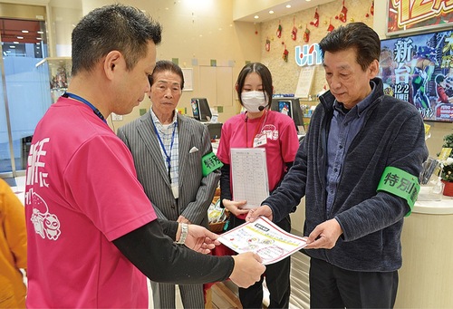 啓発物を手渡す松本組合長（右）