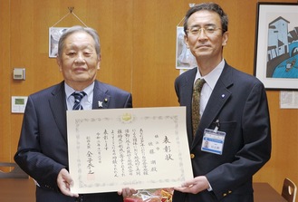 表彰状を持つ佐藤会長（左）と日比野区長