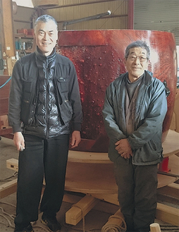 製造中の太鼓を前にほほ笑む田中代表（左）と牛山社長
