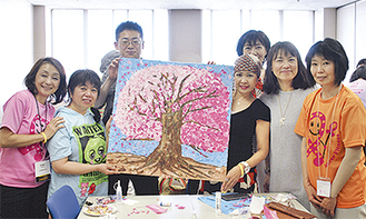 皆で作り上げたメインアートの桜を囲む参加者ら