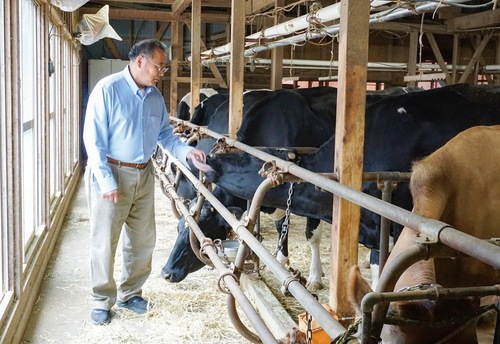 牧舎に立つ福田さん