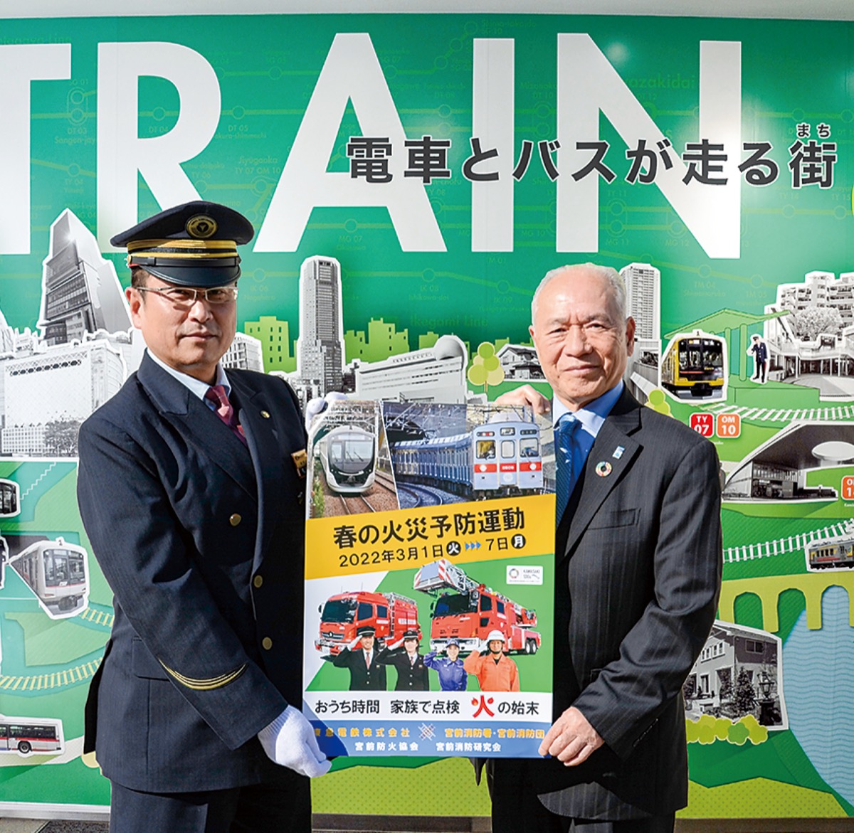 ポスターを手にする武田駅長と持田会長