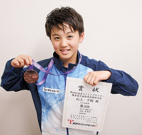 賞状とメダルを持つ山上さん