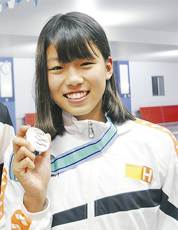 メダルを掲げる澤野莉子選手