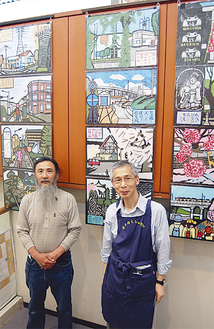 壁一面に張られた作品の前で藤田氏（左）と池原真館長（右）