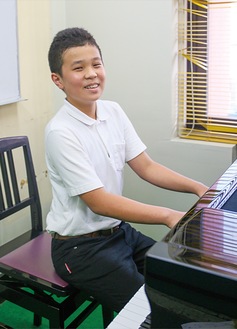 笑顔でピアノを弾く長田さん