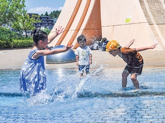 水遊びをする子どもたち＝7月30日撮影