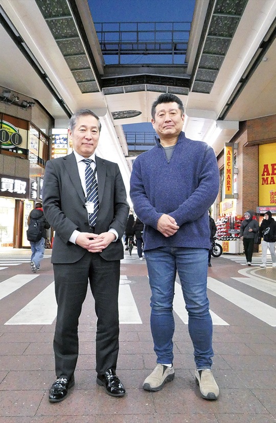 銀柳街のアーケードに立つ飛田店長（左）と吉澤理事長