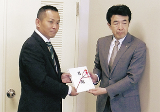 目録を手渡す青年会議所の柴田輝隆さん（左）