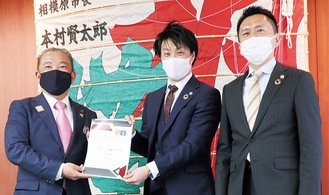 本村市長（左）に提言書を手渡す宇田川共同代表（中央）と藤田共同代表