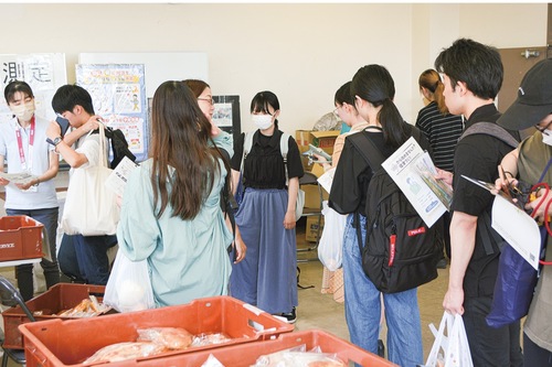 食材を受け取る大学生ら