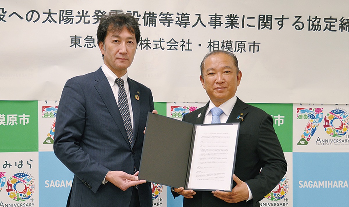 協定書を交わした本村市長と根津執行役員