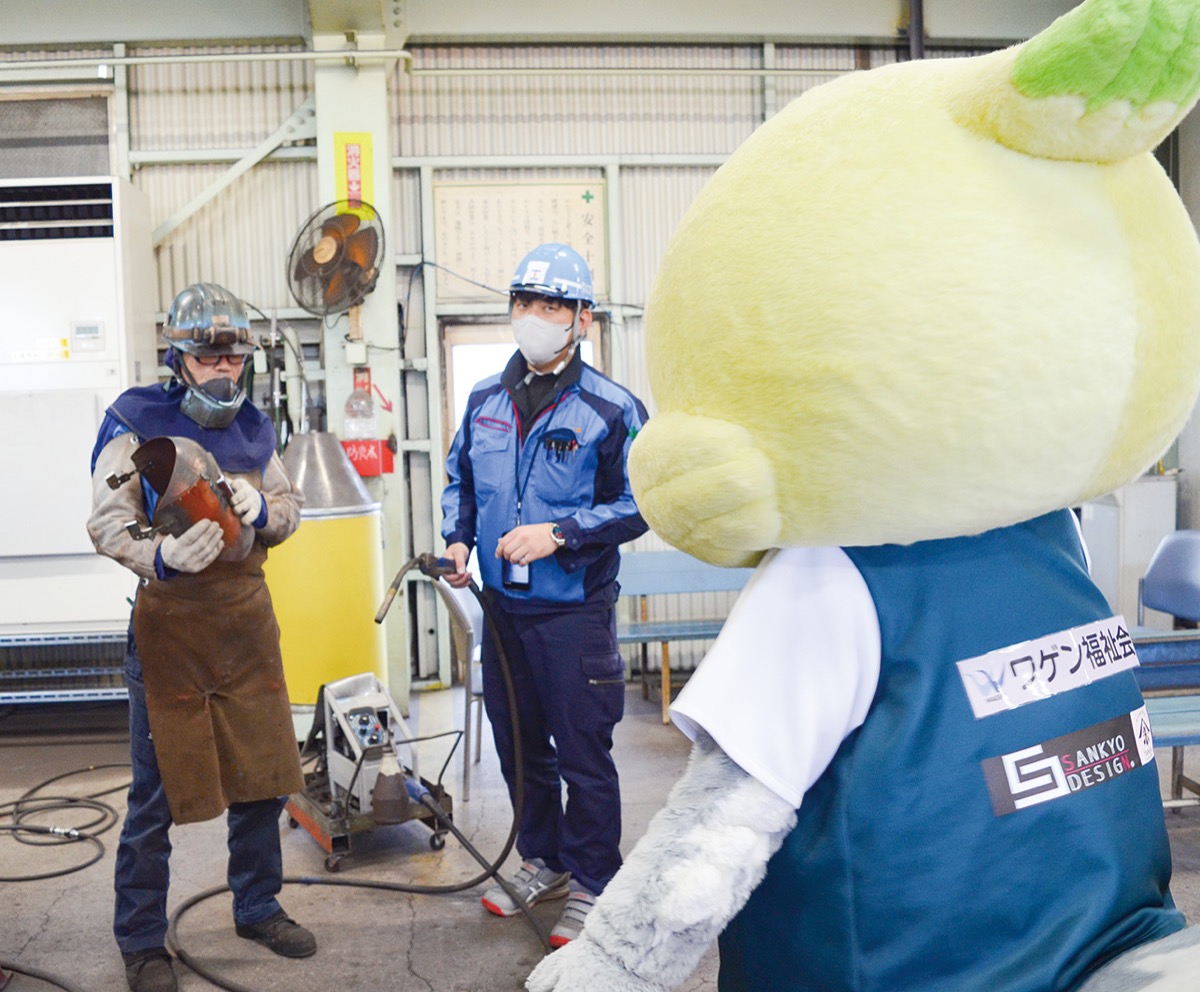 鉄骨加工についてガミティに説明する社員たち