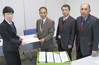 署名を提出した（右から）茅会長、植田理事長、河本会長。左端が佐村総括官補＝5日、まち・ひと・しごと創生本部
