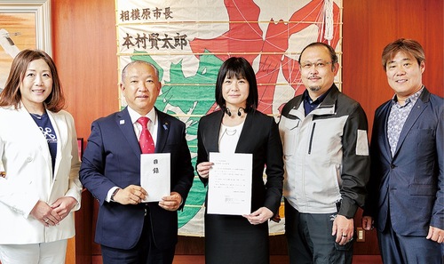 支援金を贈呈する正谷さん（左から）３人目と本村市長（同２人目）