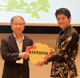 表彰式で市産業振興財団の石川敏美常務理事（左）から副賞を贈られる宮嵜さん