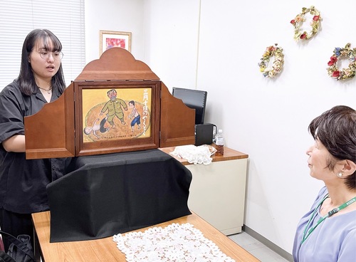 岩佐さん（右）を前に紙芝居の練習をするチェさん
