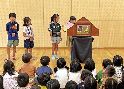 園児の前で紙芝居を披露する児童