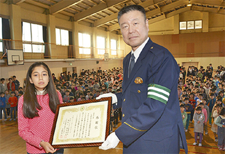 全校児童が見守る中、池田署長（右）から表彰状を受けた