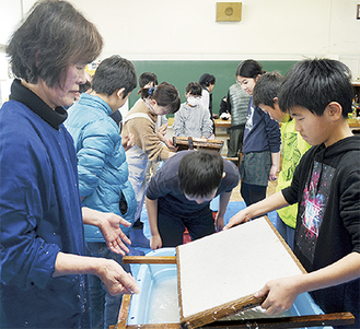 ひまわり和紙作りを体験する児童