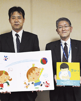 絵本を手にする同事業所の宮田仁さん（左）と青木晃彦さん