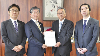 川口委員長（中央右）が石井議長に答申書を手渡した
