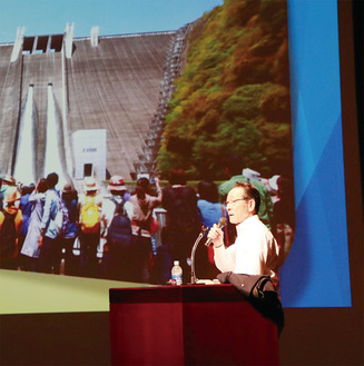 パワーポイントの映像をもとに、町の歴史や重点施策を語る小野澤町長